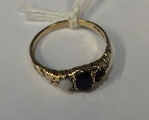 A 9 carat three stone ring in claw mount. Est. £30