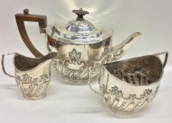 A heavy silver half fluted tea set. London. By LS&