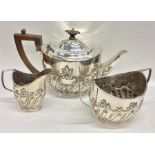 A heavy silver half fluted tea set. London. By LS&