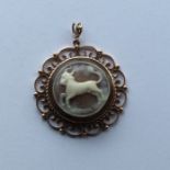 An oval cameo of a goat in gold frame. Approx. 9.4