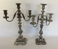 A pair of large silver plated embossed candelabra.