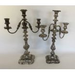 A pair of large silver plated embossed candelabra.