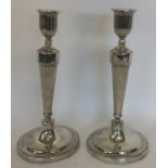 A pair of Georgian fluted candlesticks with beaded