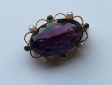 SUFFRAGETTE: A rare amethyst oval brooch with pear
