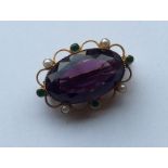 SUFFRAGETTE: A rare amethyst oval brooch with pear