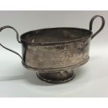 A silver circular sugar bowl with reeded handles.