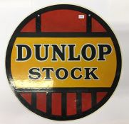 A circular "Dunlop Stock" double sided metal and e