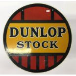 A circular "Dunlop Stock" double sided metal and e