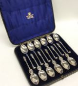 An unusual set of six (plus six) silver coffee spo