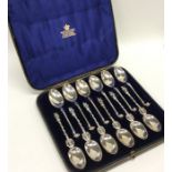 An unusual set of six (plus six) silver coffee spo