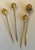 A group of four gold high carat hat pins. Approx.