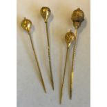 A group of four gold high carat hat pins. Approx.