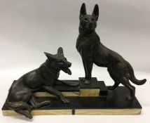 A large marble mounted statue of two Alsatians. Es