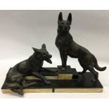 A large marble mounted statue of two Alsatians. Es