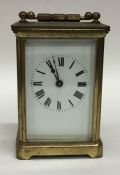 A small brass cased carriage clock with white enam