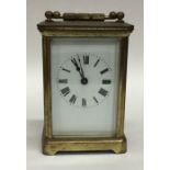 A small brass cased carriage clock with white enam