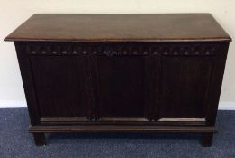 An oak carved front coffer with hinged top. Est. £