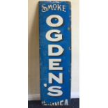 A rectangular "Smoke Ogden's" metal and enamel sig