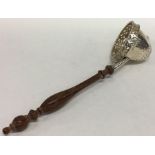 An unusual silver tea strainer with pierced rim an