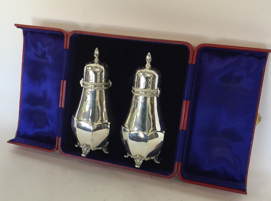 An attractive boxed pair of silver sugar casters w