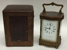 A brass carriage clock with white enamelled dial i