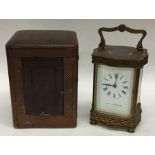 A brass carriage clock with white enamelled dial i