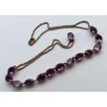 A good quality Antique amethyst necklace in claw m