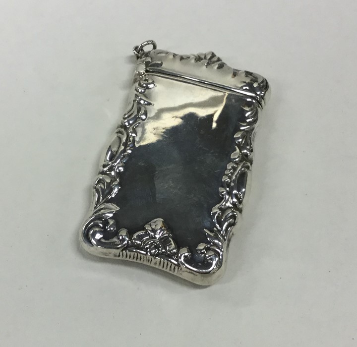 A modern silver hinged top vesta case decorated wi