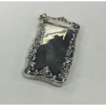 A modern silver hinged top vesta case decorated wi
