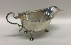 An Edwardian silver sauce boat with card cut rim a