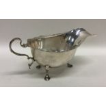 An Edwardian silver sauce boat with card cut rim a