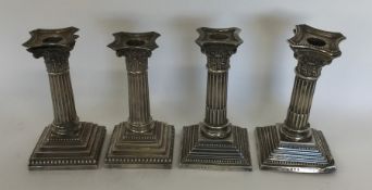 A set of four silver Corinthian column candlestick