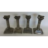 A set of four silver Corinthian column candlestick