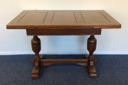 An oak drawer leaf table with plank top and stretc