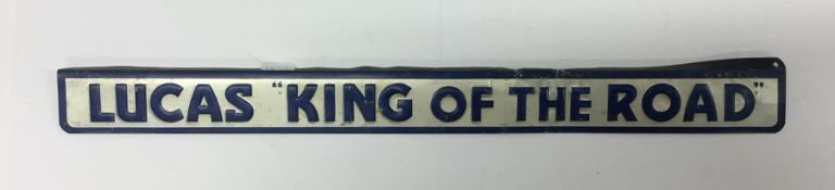 A small rectangular "Lucas King of The Road" metal