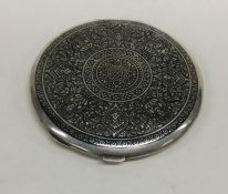 A heavy circular Eastern silver compact with Niell