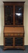 An Edwardian glazed mahogany bookcase on bracket f