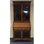 An Edwardian glazed mahogany bookcase on bracket f