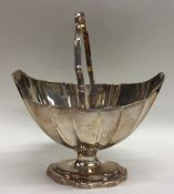 A Georgian silver swing handled basket with reeded