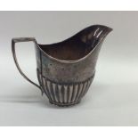 A small silver half fluted cream jug. Sheffield. A