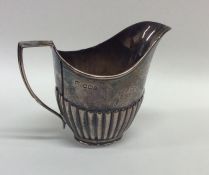 A small silver half fluted cream jug. Sheffield. A