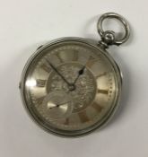 A large silver open face pocket watch with silvere