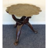 A small circular hardwood table with brass top. Es