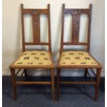 A pair of oak Gothic hall chairs with upholstered