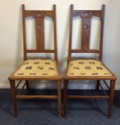 A pair of oak Gothic hall chairs with upholstered