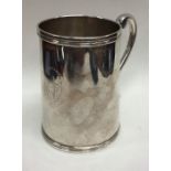 A heavy silver Continental tapering mug with scrol