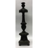 A large Gothic candle holder with carved decoratio