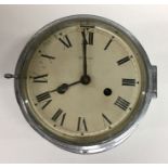 A large silvered ship's clock with white enamelled