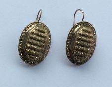 A pair of unusual gold ear pendants with ball deco