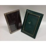 A plain silver picture frame together with a leath